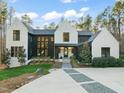 Beautiful two-story home with modern black and white design, professionally landscaped front yard, and inviting entryway at 336 Timberline Dr, Pittsboro, NC 27312