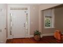 Welcoming foyer with white trim and hardwood floors, showcasing natural light from side windows at 400 Leacroft Way, Morrisville, NC 27560