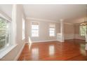 Bright living room with hardwood floors, large windows, and detailed trim at 400 Leacroft Way, Morrisville, NC 27560