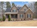 Beautiful two-story home with a covered front porch, manicured landscaping, and mixed siding at 442 Hunters Pointe Rd, Nashville, NC 27856