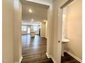 Inviting entryway showcases pristine hardwood floors and an open floor plan with a view of the kitchen and living area at 5014 Kota St, Raleigh, NC 27610