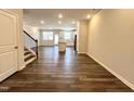 Bright and airy living room with gleaming floors, stairs to the upper floor, and an open concept layout at 5014 Kota St, Raleigh, NC 27610