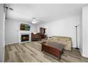 Cozy living room with a fireplace, neutral paint, and modern flooring at 513 Jaffiley Ct, Wake Forest, NC 27587