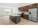 Spacious kitchen with stainless appliances, island and modern design at 607 Silverado Sunset Loop, Wendell, NC 27591