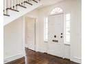 Bright foyer features hardwood floors, a white front door with sidelights, and a staircase at 610 Peele St, Burlington, NC 27215