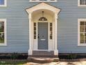 Close-up of the entryway showing the detailed front door with decorative trim and columns at 610 Peele St, Burlington, NC 27215