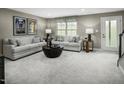 Cozy, neutral-toned living room features comfortable seating and natural light at 611 Silverado Sunset Loop, Wendell, NC 27591