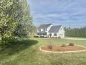 Inviting two-story home with lush front lawn and meticulously maintained landscaping at 723 Whitt Town Rd Rd, Roxboro, NC 27574
