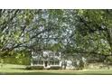 Lovely two-story home with a covered porch, surrounded by mature trees and a well-kept lawn at 723 Whitt Town Rd Rd, Roxboro, NC 27574