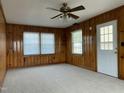 Cozy room features wood paneling, new carpet, a ceiling fan with lights, and lots of sunlight at 736 Core Rd Rd, Dunn, NC 28334