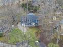 Aerial view of the blue two-story home nestled among trees with its surrounding neighborhood at 8304 Circlewood Ct, Raleigh, NC 27615