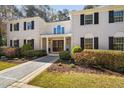 Elegant white brick home with a symmetrical facade and manicured landscaping at 100 Dunedin Ct, Cary, NC 27511