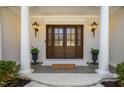 Elegant entryway with columns, outdoor lanterns, and a welcoming front door at 100 Dunedin Ct, Cary, NC 27511