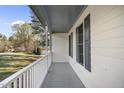 This home features a cozy front porch with painted wood and views of the surrounding neighborhood at 1012 Mountain Laurel Dr, Raleigh, NC 27603
