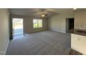 Spacious living room featuring neutral paint, modern fan, and plush carpet flooring at 108 Faucette Dr, Selma, NC 27576
