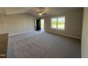 Cozy living room showcasing plush carpet flooring and a window providing plenty of natural light at 108 Faucette Dr, Selma, NC 27576