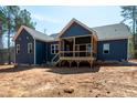 Newly built home with blue siding, a spacious backyard, and a covered wooden deck, perfect for outdoor gatherings at 110 Purslane Dr, Franklinton, NC 27525