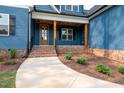 Close up of home's covered porch and front door with brick base and wood supports at 110 Purslane Dr, Franklinton, NC 27525