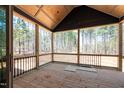 Outdoor screened-in porch with wood flooring, overlooking a peaceful wooded area, for relaxing and entertaining at 110 Purslane Dr, Franklinton, NC 27525