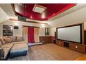 Enjoy movies in this carpeted home theater with projector, large screen, and comfortable seating at 113 Kings Castle Dr, Apex, NC 27502