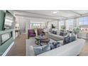 Open-concept living room with modern furnishings, fireplace, and view of the kitchen at 1234 Coach Station Alley # 201, Raleigh, NC 27601