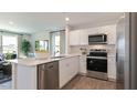 Modern kitchen with stainless steel appliances, quartz countertops, and open layout at 146 Holton St, Smithfield, NC 27577