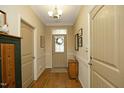 Inviting foyer featuring hardwood floors, neutral walls, and decorative lighting, creating a warm and elegant entrance at 1914 Tweed Ln, Burlington, NC 27215