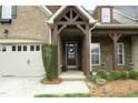 A welcoming entryway with a custom wood porch and decorative front door, enhancing the home's curb appeal at 1914 Tweed Ln, Burlington, NC 27215