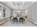 Beautiful dining room features modern chandelier, gray walls, and a large window with natural light at 2829 Theresa Eileen Way, Raleigh, NC 27603