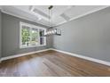Bright dining room with modern light fixture, coffered ceilings, and hardwood floors at 2829 Theresa Eileen Way, Raleigh, NC 27603