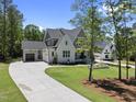 Expansive view of the home with a spacious driveway and well-maintained lawn and greenery at 2829 Theresa Eileen Way, Raleigh, NC 27603