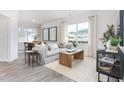 Bright living room featuring hardwood floors, large windows, and modern decor throughout at 2832 Egert Dr, Haw River, NC 27258