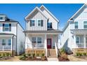 Beautiful home with a welcoming front porch and well-manicured landscaping at 305 Wash Hollow Dr, Wendell, NC 27591