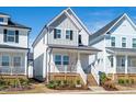 Charming home featuring a welcoming front porch and beautiful landscaping at 305 Wash Hollow Dr, Wendell, NC 27591