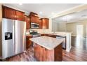 Well-equipped kitchen with stainless steel appliances, granite countertops, and a functional center island at 317 Michigan Ave, Cary, NC 27519