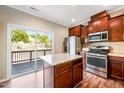 Spacious kitchen offering stainless appliances, central island, and sliding glass door access to outdoor deck at 317 Michigan Ave, Cary, NC 27519