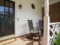 Cozy front porch with rocking chairs and brick flooring, offering a relaxing outdoor space at 3321 Marblehead Ln, Raleigh, NC 27612