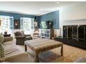 Comfortable living room with blue accent walls, fireplace, and large windows, creating a welcoming atmosphere at 3321 Marblehead Ln, Raleigh, NC 27612