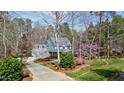 A home's aerial view, surrounded by lush landscaping, mature trees, and a private driveway at 3424 Forest Oaks Dr, Chapel Hill, NC 27514