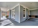 Relaxing porch with a wooden swing, neutral walls, and ample natural light at 3424 Forest Oaks Dr, Chapel Hill, NC 27514