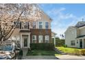 Charming townhome with brick accents, green door, and blossoming tree at 3615 Ramblewood Ave, Durham, NC 27713