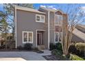 Charming townhouse featuring a well-maintained exterior and landscaped front yard with lush greenery at 4 Applewood Sq, Durham, NC 27713