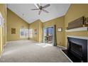 Bright living room featuring vaulted ceilings, a fireplace, and sliding glass doors to a patio at 4 Applewood Sq, Durham, NC 27713