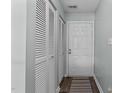 Hallway with coat closet and neutral decor at 4631 Timbermill Ct # 301, Raleigh, NC 27612