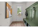 Welcoming entryway with a hall tree, a bench, and modern artwork at 4706 Cypress Tree Ln, Raleigh, NC 27612