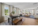 Open-concept living space with wood floors, dining area and a comfortable living room at 4706 Cypress Tree Ln, Raleigh, NC 27612