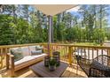 Relaxing outdoor patio furnished with cozy couch, woven chair, and natural views at 4706 Cypress Tree Ln, Raleigh, NC 27612