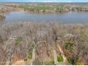 Breathtaking aerial view of the home, revealing its private setting with lake access and lush surrounding landscape at 4808 Clubview Ct, Fuquay Varina, NC 27526