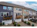 Townhome exteriors showcase balconies and attached garages at 4963 Highcroft Dr, Cary, NC 27519