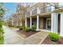 Attractive townhomes featuring covered entrances and tidy landscaping at 4963 Highcroft Dr, Cary, NC 27519